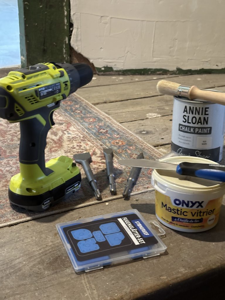 the slow renovation - Drill, glazing tools, and Annie Sloan chalk paint on the unfinished floor of a 170-year-old French stone house